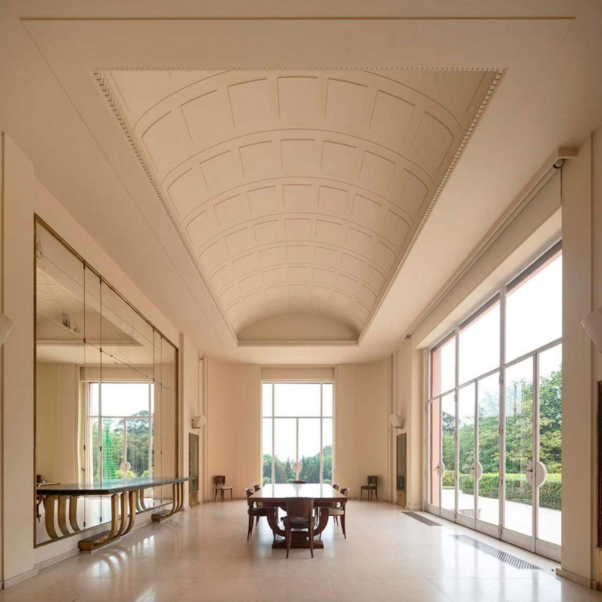 a large room with a table and large windows