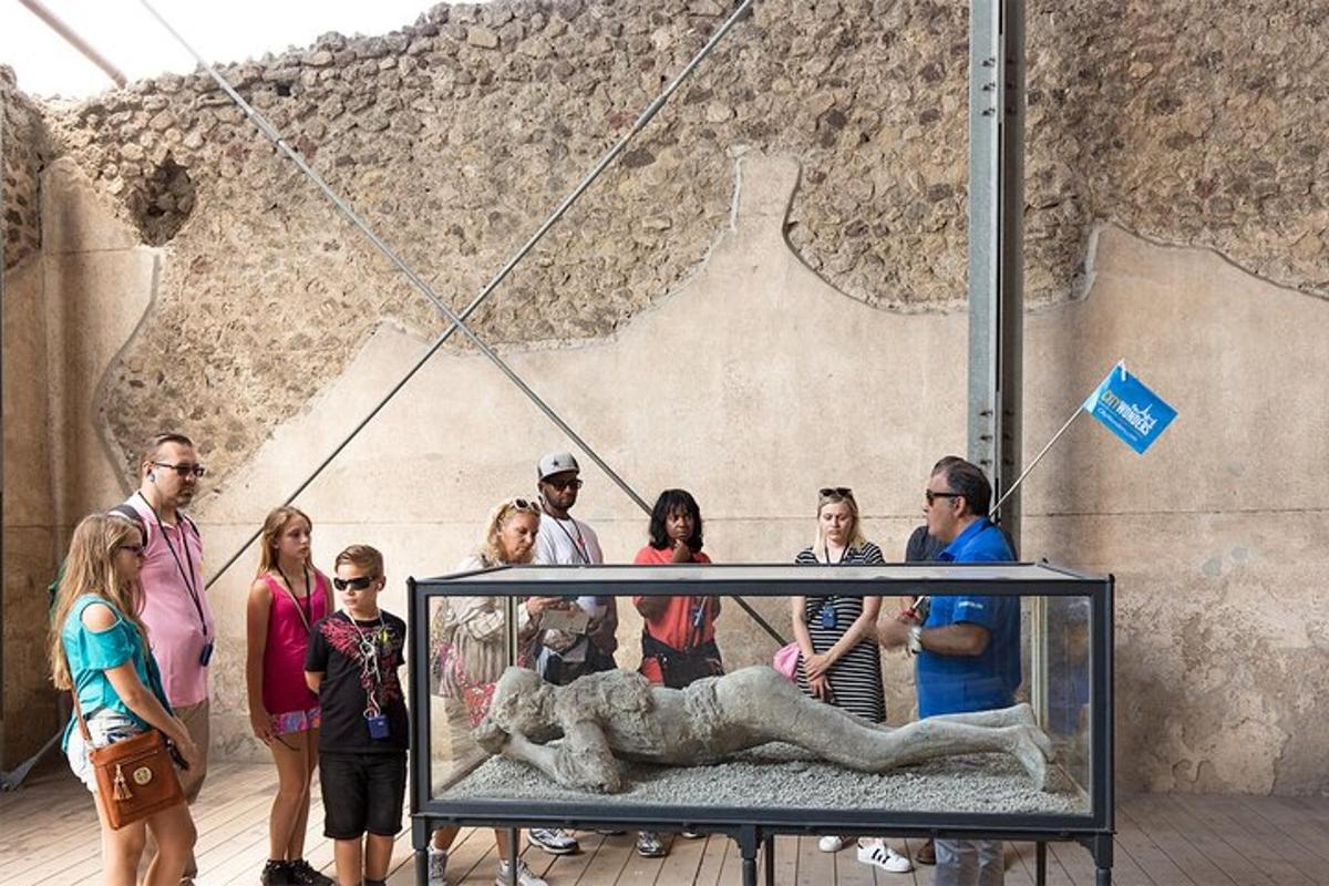 a group of people standing in front of a lion statue