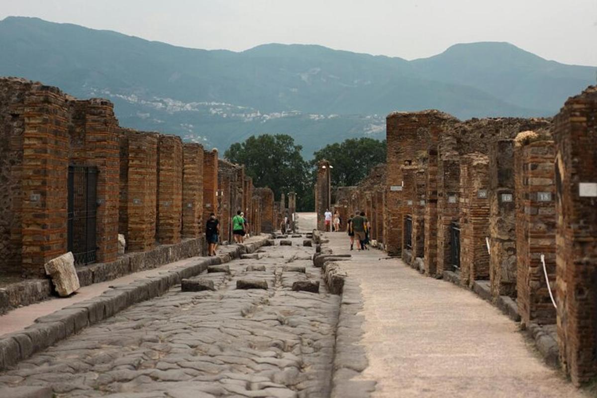 řada ruin s lidmi jdoucími po ulici