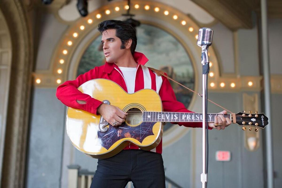 a man holding a guitar and a microphone
