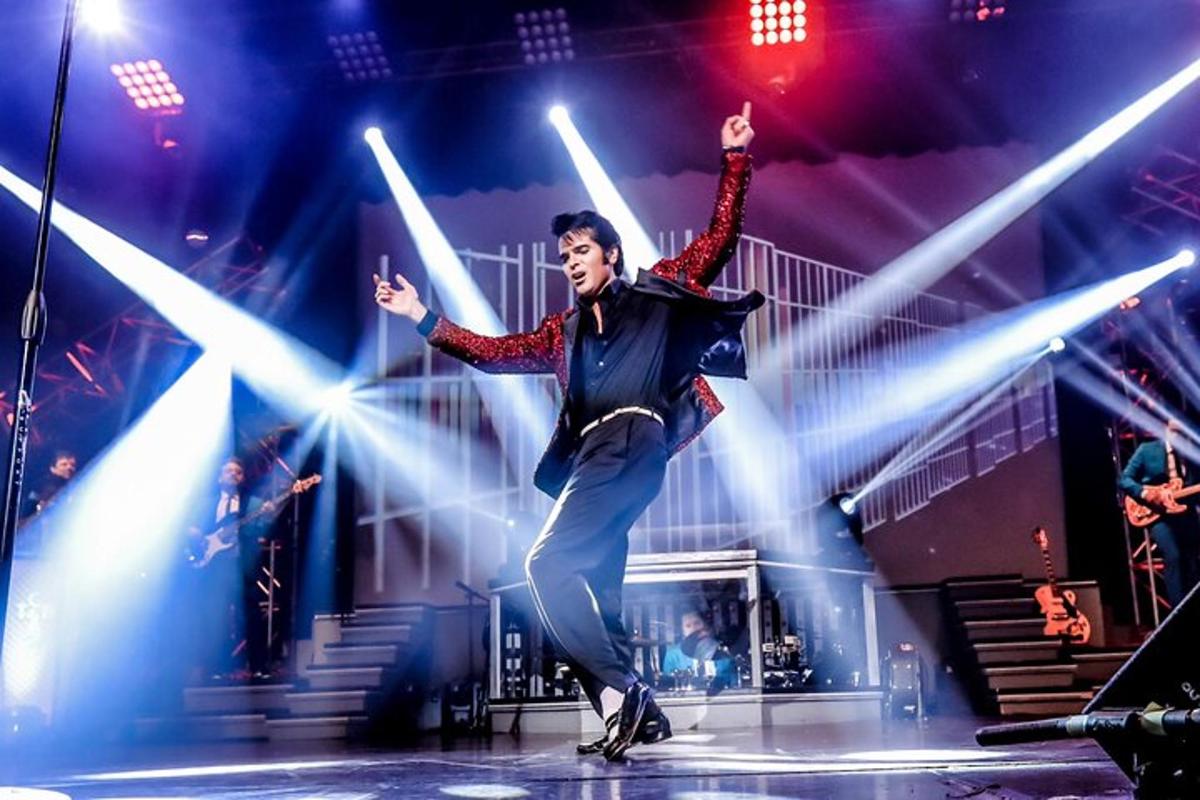 a man on a stage with his arms in the air