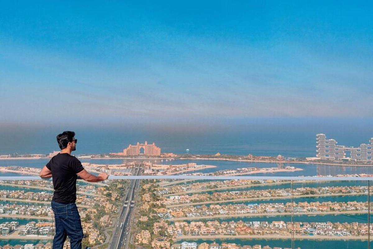 a man standing on top of a tower looking at a city