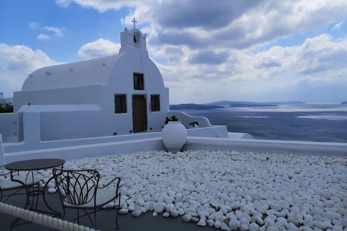 a white building with a table and chairs in front of it