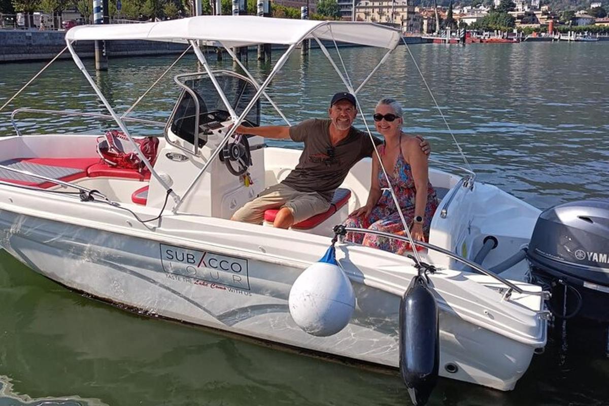 two people sitting on a boat in the water