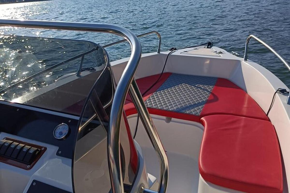 a boat with a red seat on the water