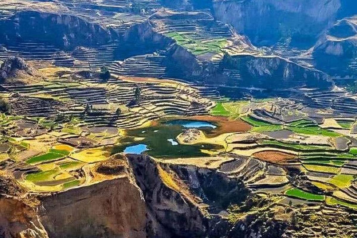 an aerial view of a golf course on a mountain