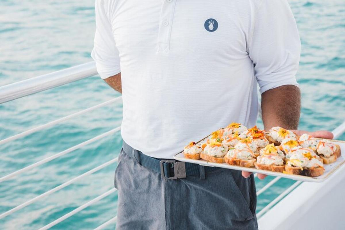 a man holding a tray of food on a boat
