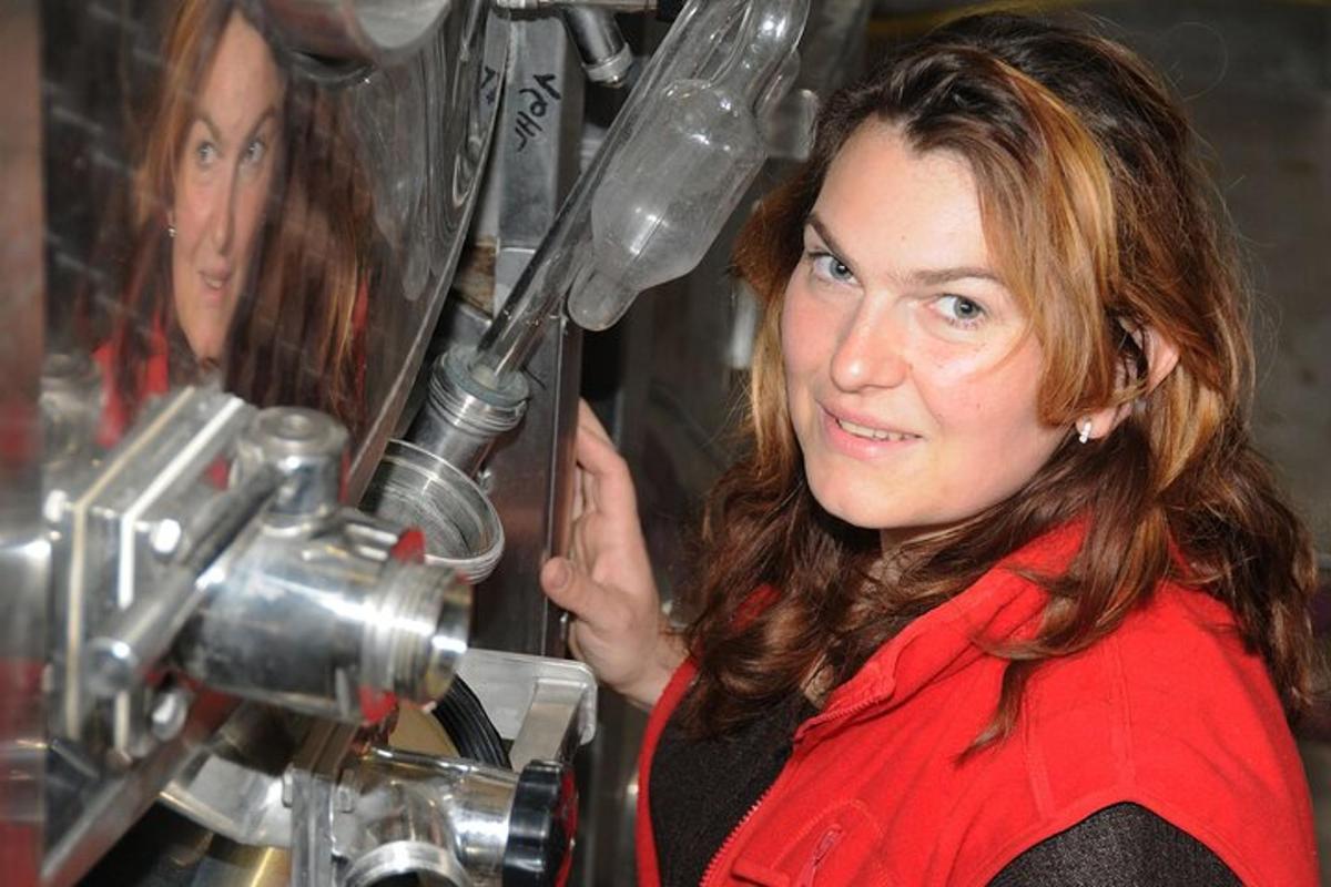 a woman is standing in front of a machine
