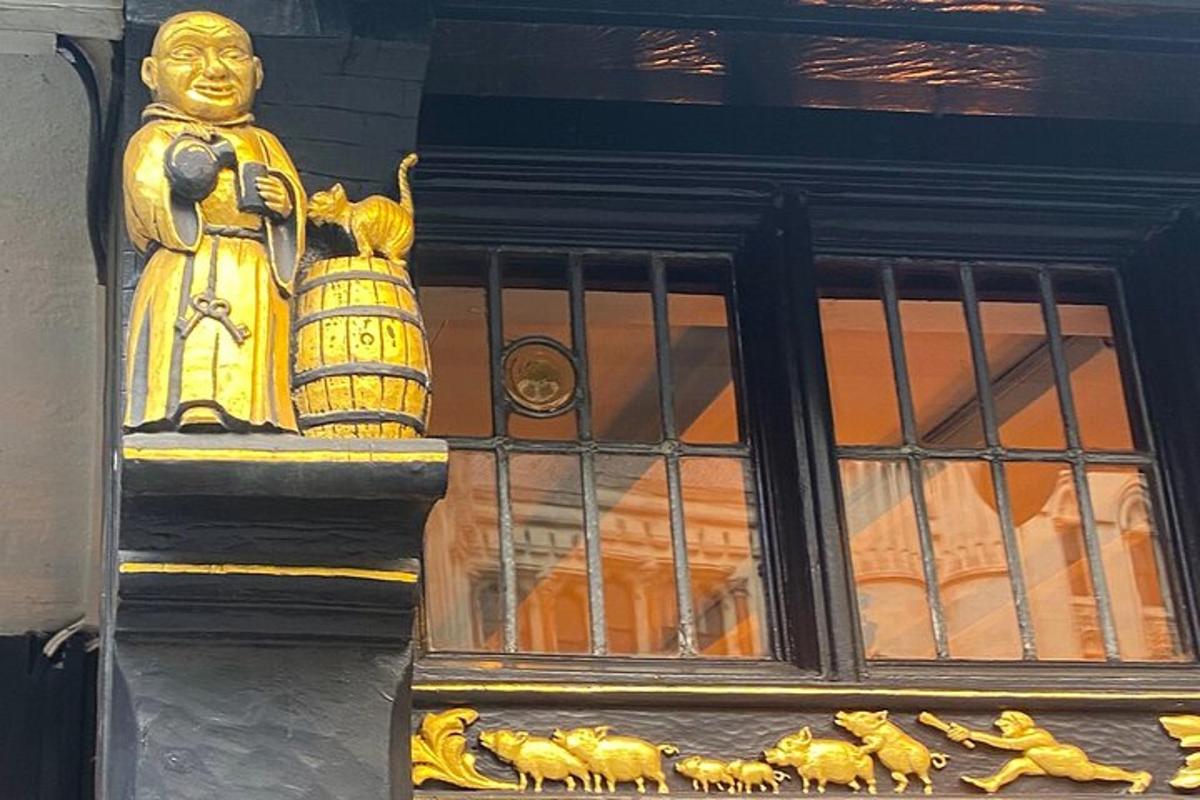 a golden statue of a man holding a basket on a building