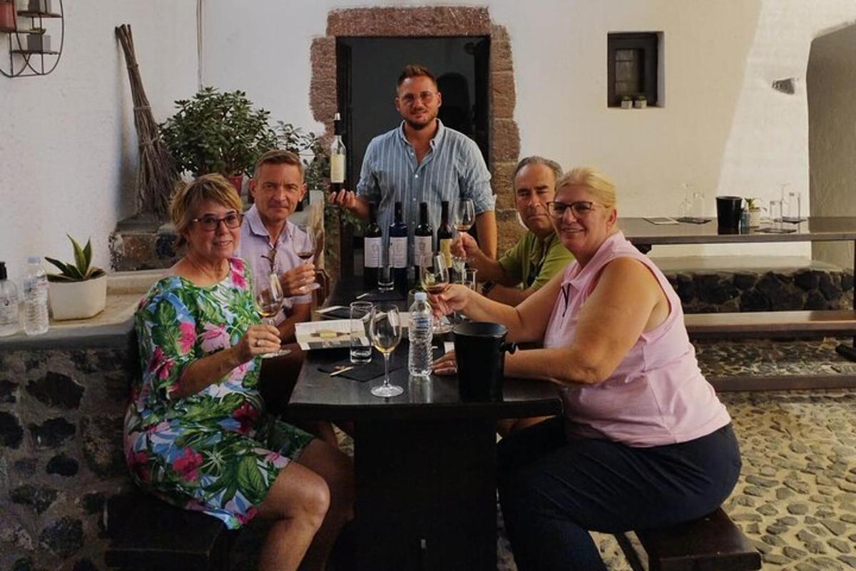 a group of people sitting at a table with wine glasses