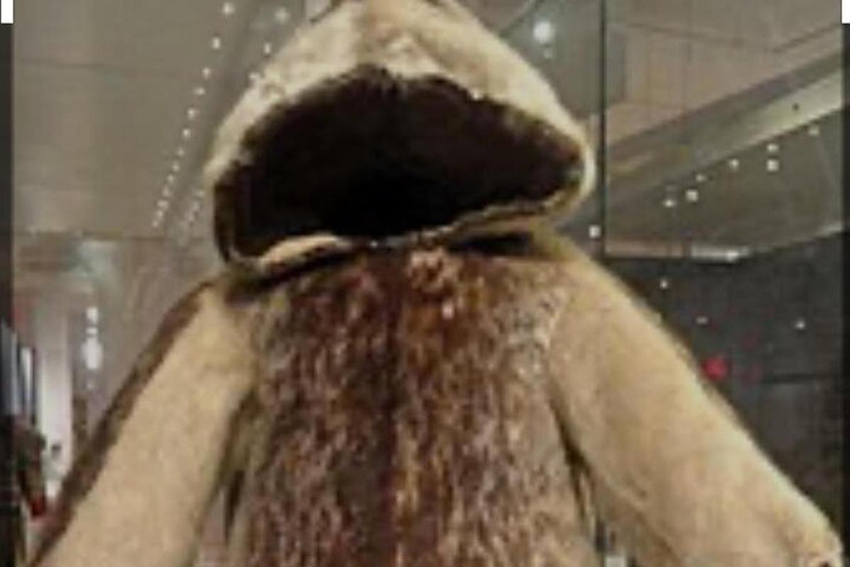 a person wearing a hat with snow on their