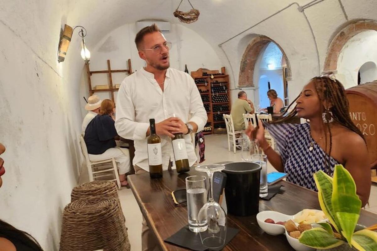 a man and a woman sitting at a table with wine bottles