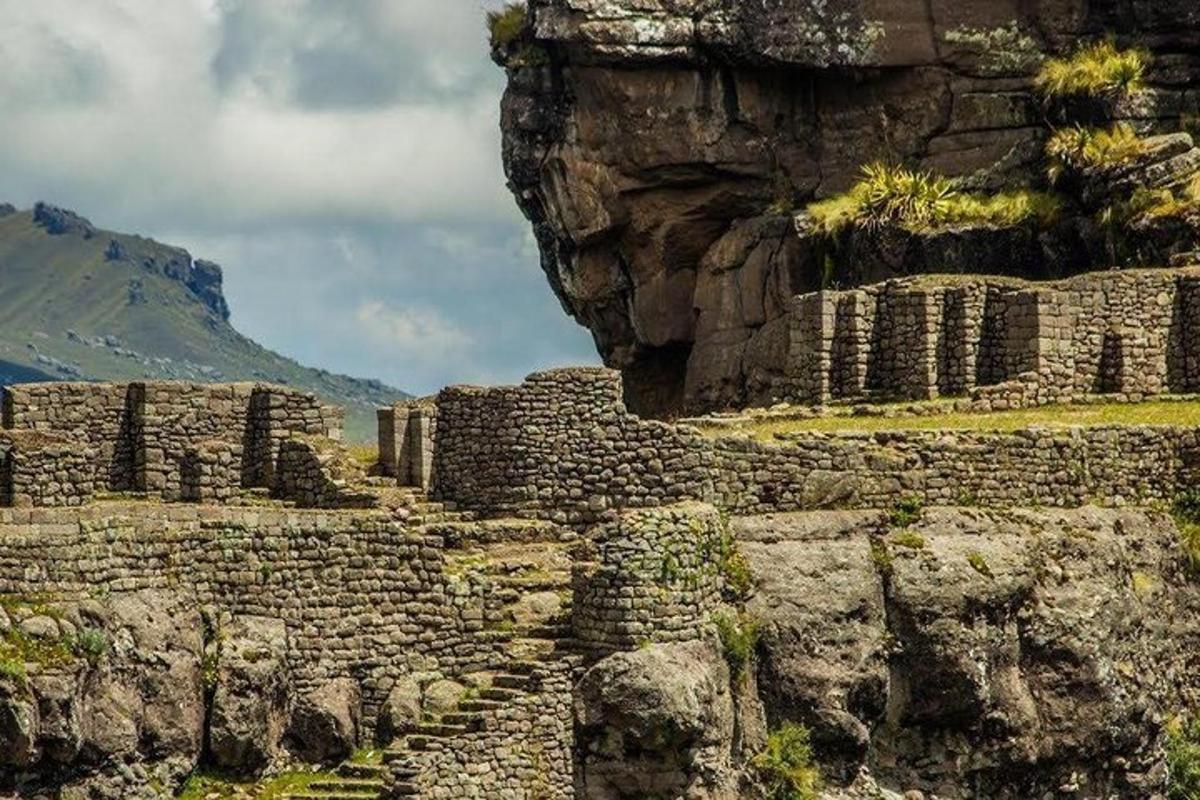 a group of ruins on the side of a mountain