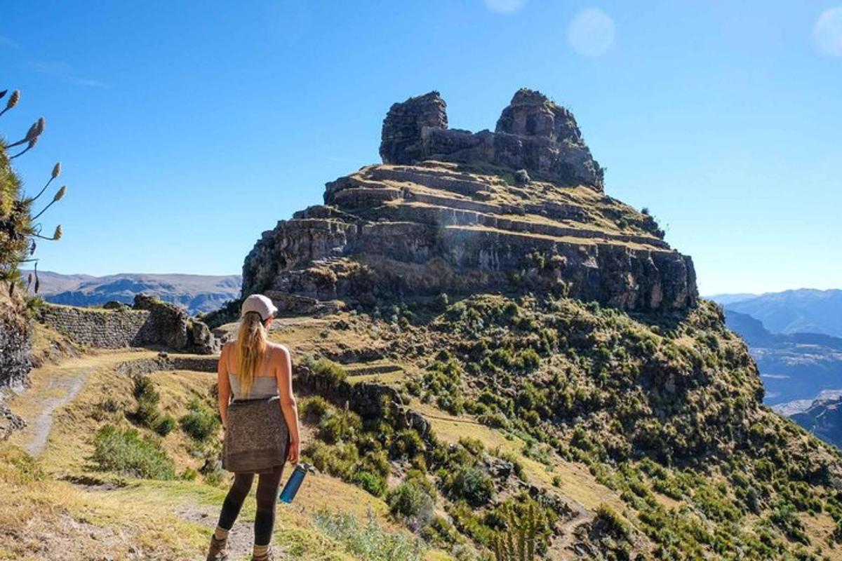 a woman standing on top of a mountain