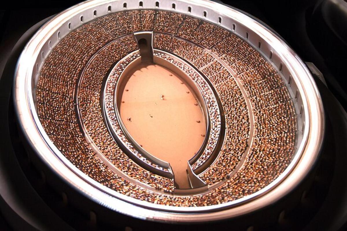 a close up of a metal pot with a brown liquid