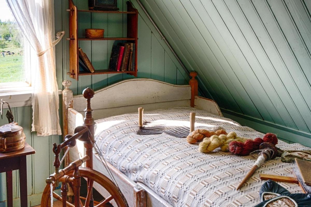 a bedroom with a bed with a table