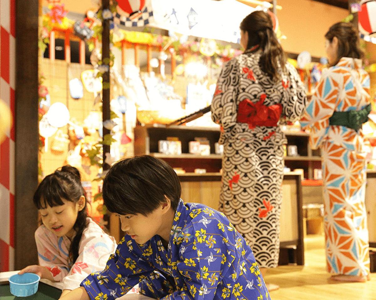 a couple of young children sitting in a store
