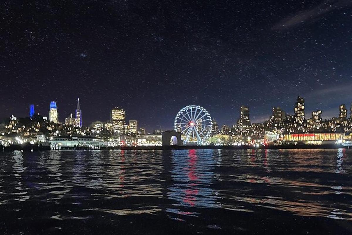 a city skyline with a ferris wheel at night