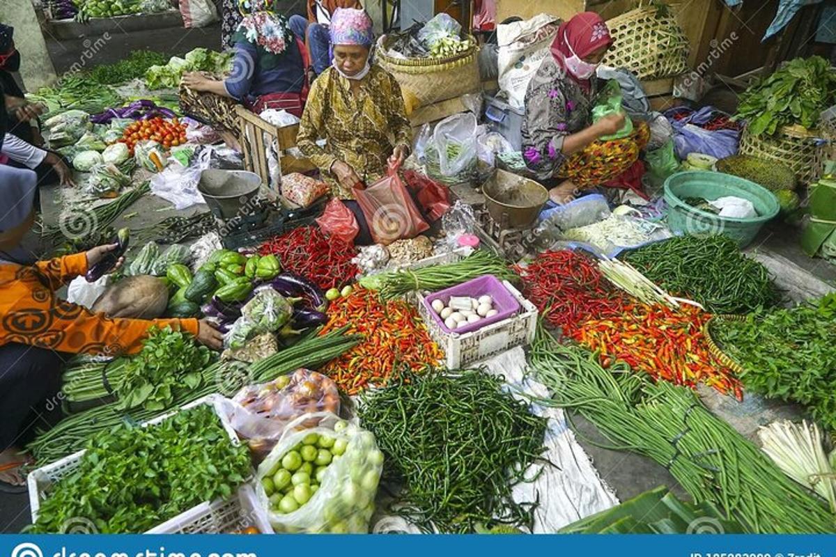 a group of people sitting at a market with vegetables