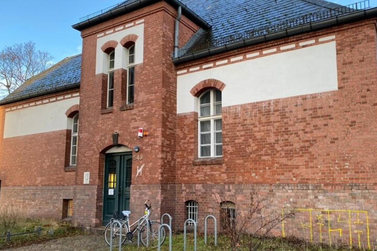 cihlová budova se dvěma zaparkovanými koly před ní
