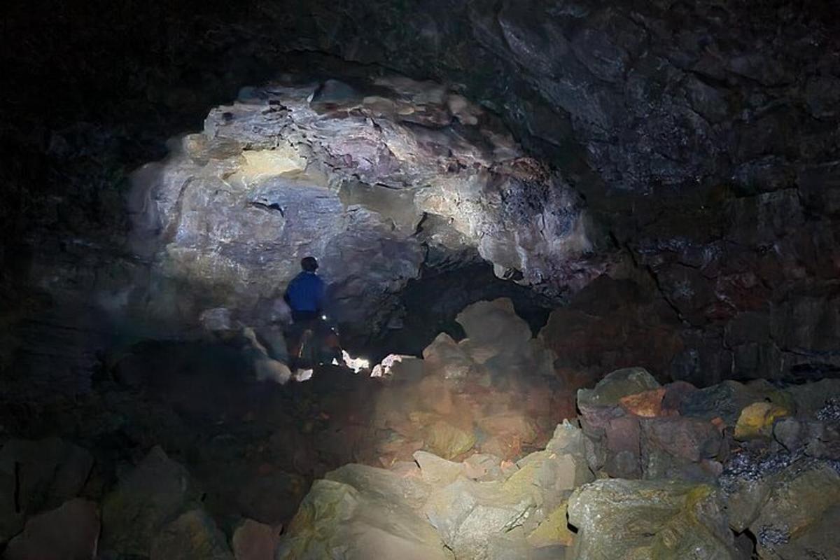 a man standing inside of a cave