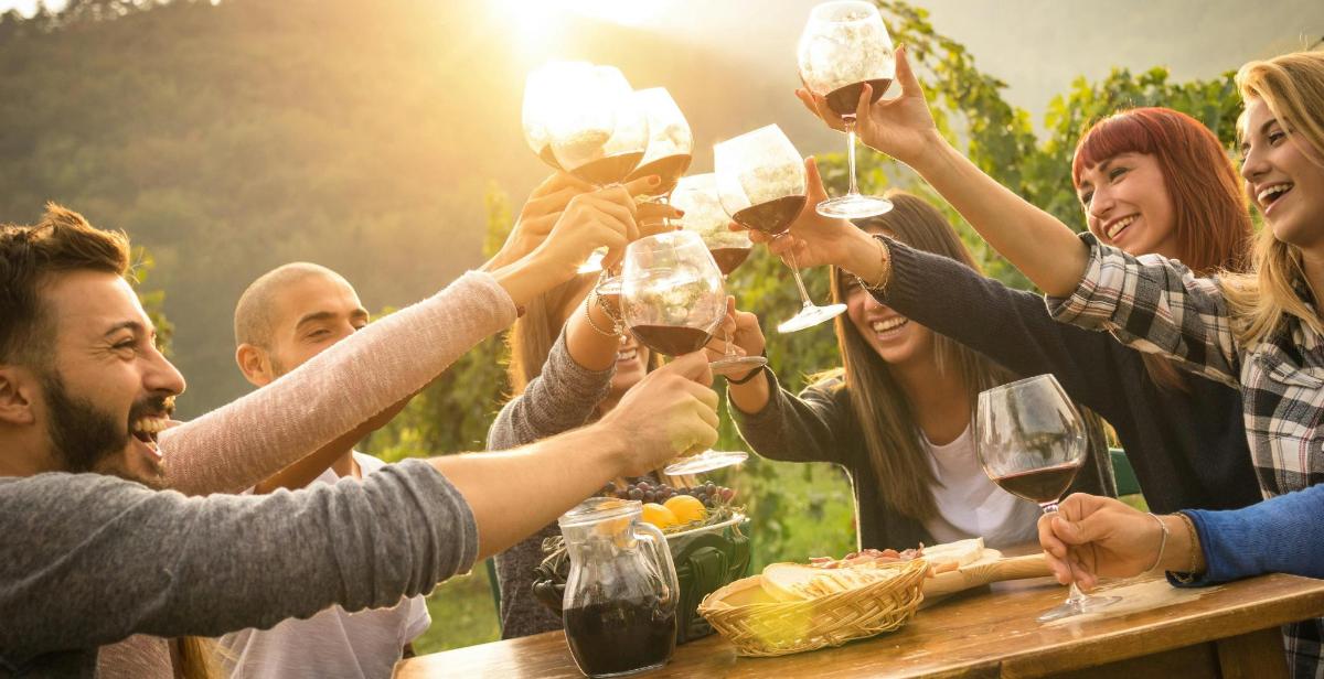 a group of people holding up glasses of wine