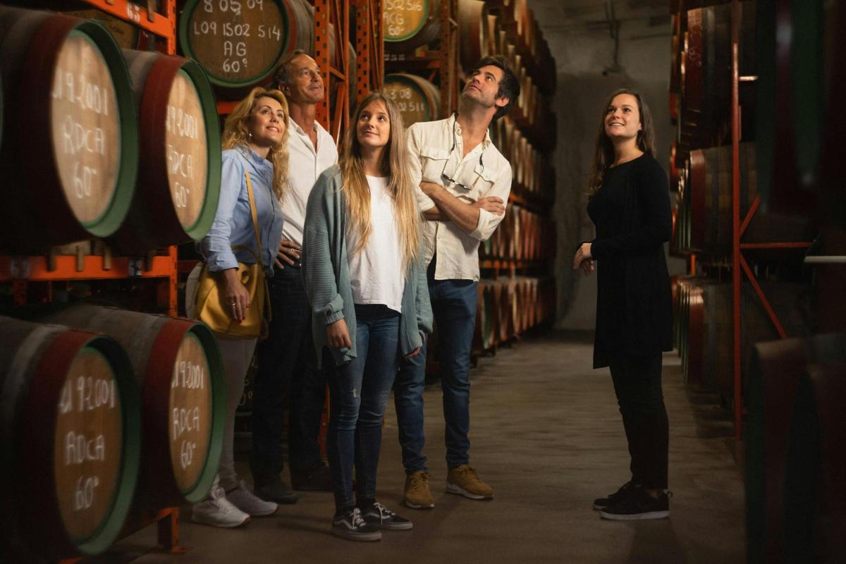 un gruppo di persone in piedi in una cantina vinicola