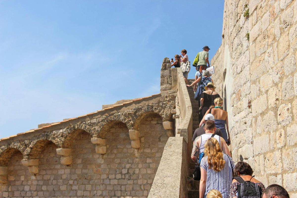 a group of people walking up a wall