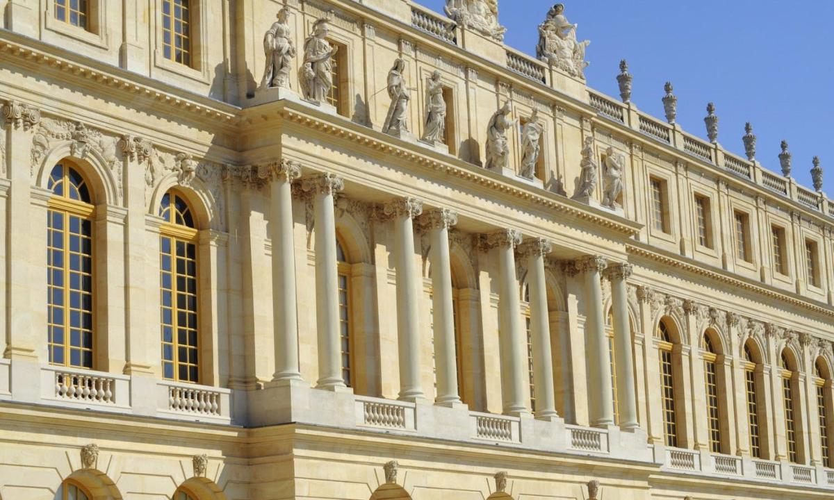 a large building with statues on top of it