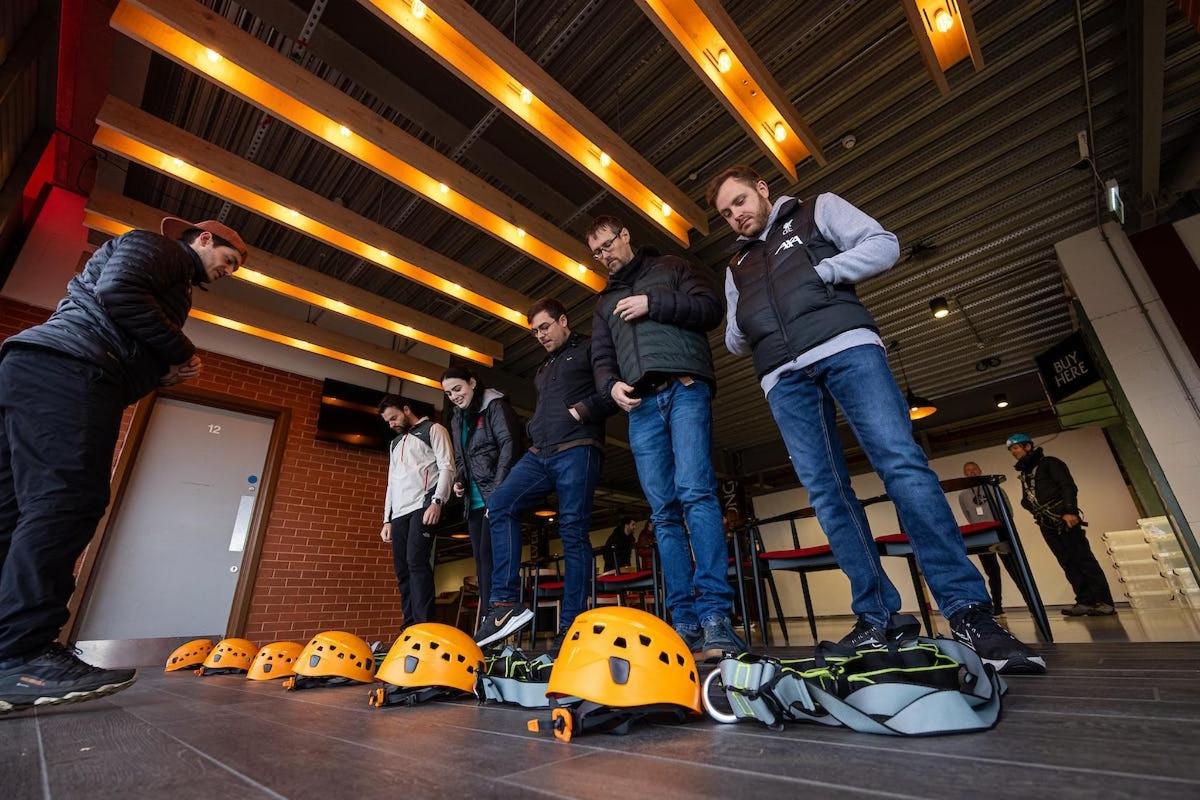 a group of men standing in front of helmets