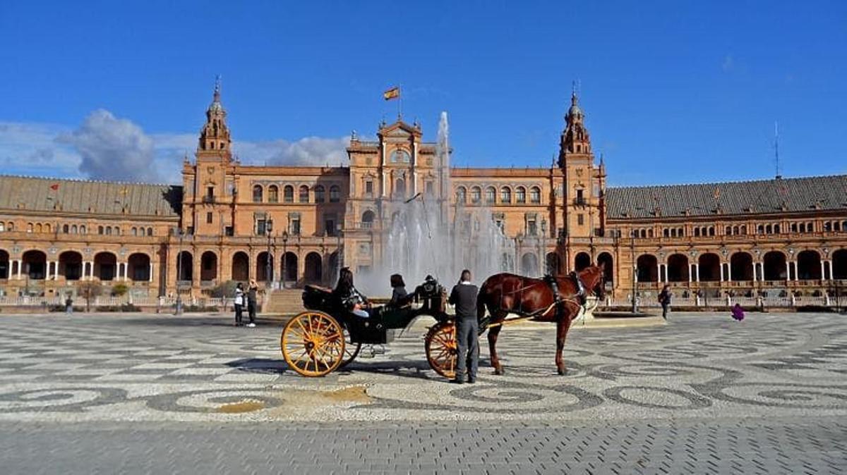 Un carruaje tirado por caballos frente a un gran edificio