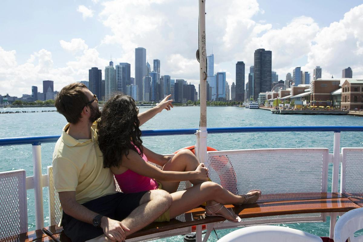 a man and woman sitting on a boat in the water