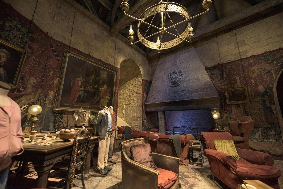 a living room with a fireplace and a table and chairs