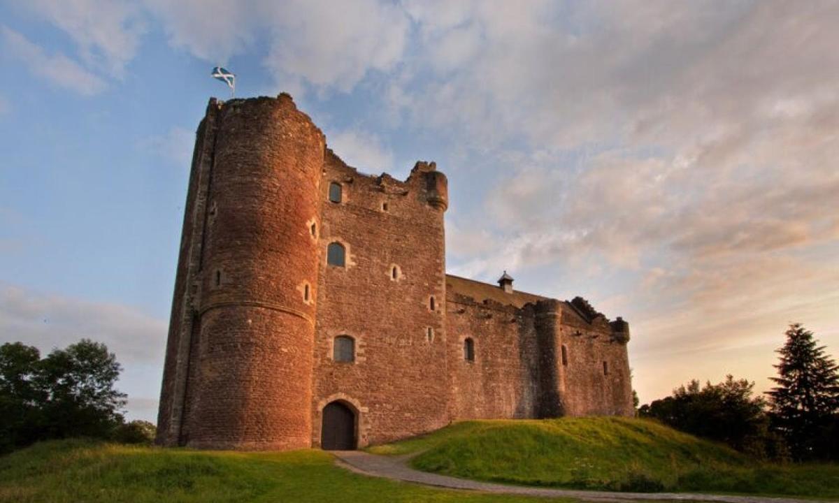 a castle on top of a grassy hill