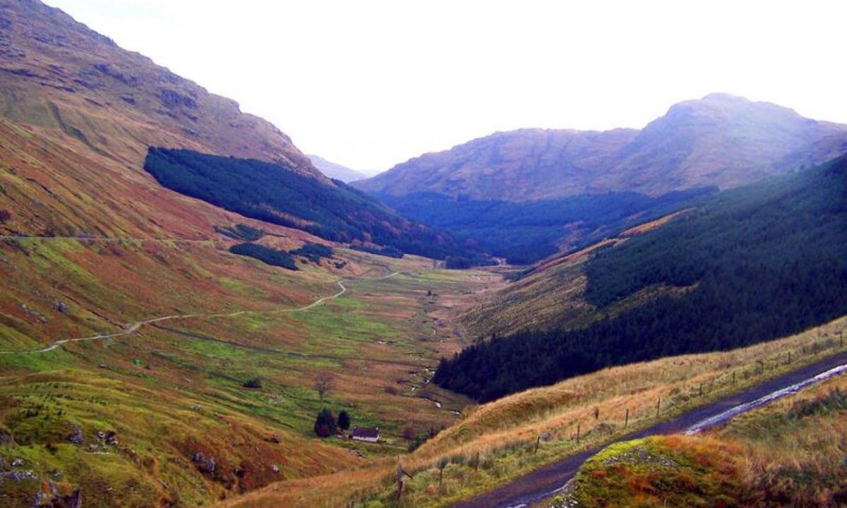a view of a valley in the mountains with a river