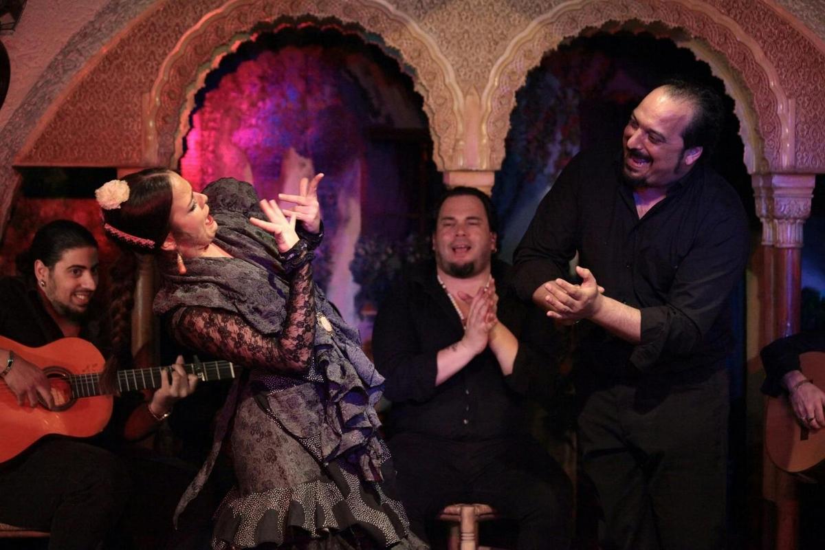 a man and a woman singing in a performance