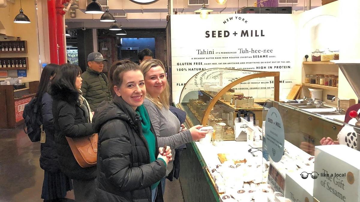 Dos mujeres de pie junto a un mostrador en una tienda.