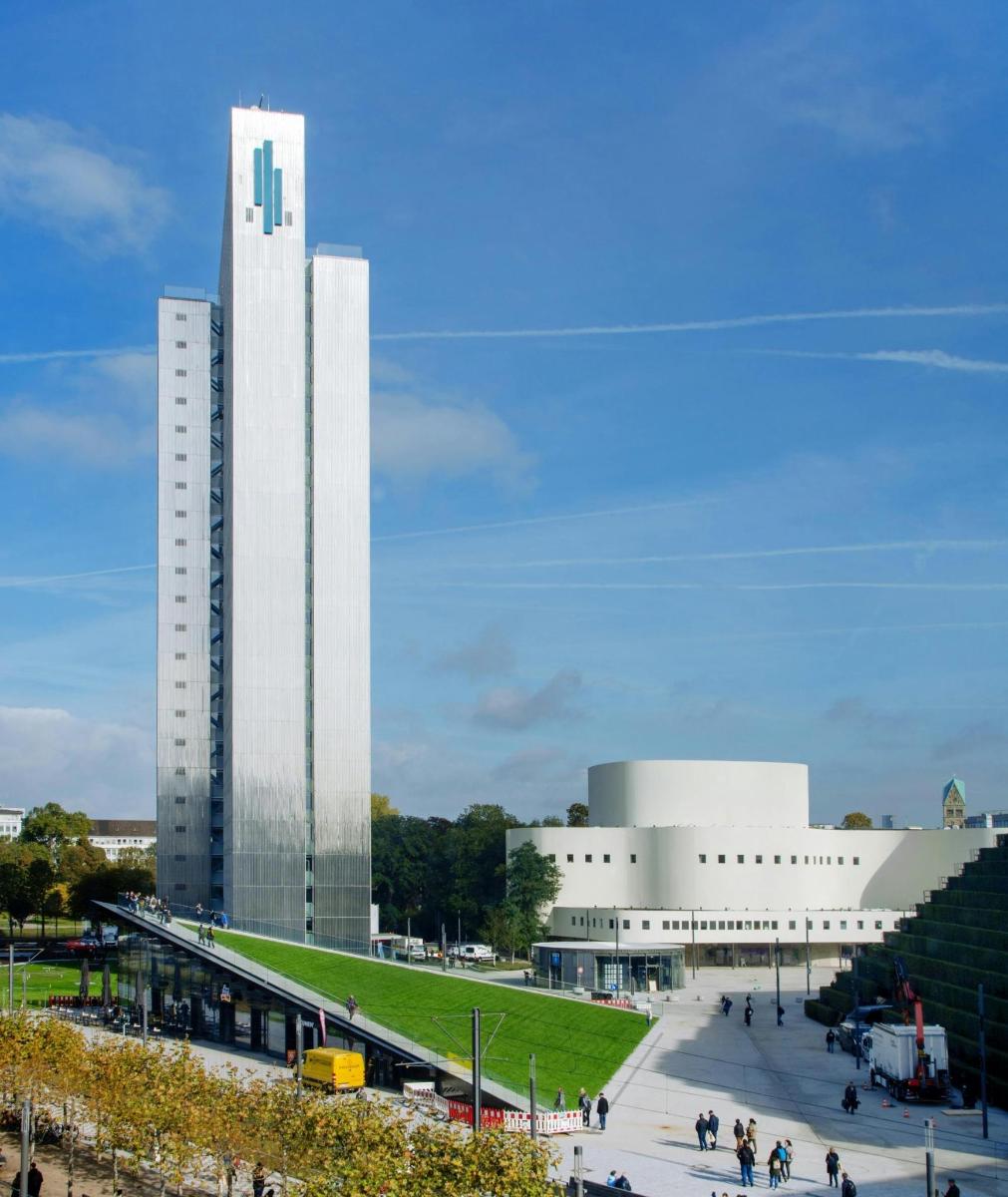a large white building with people walking around it