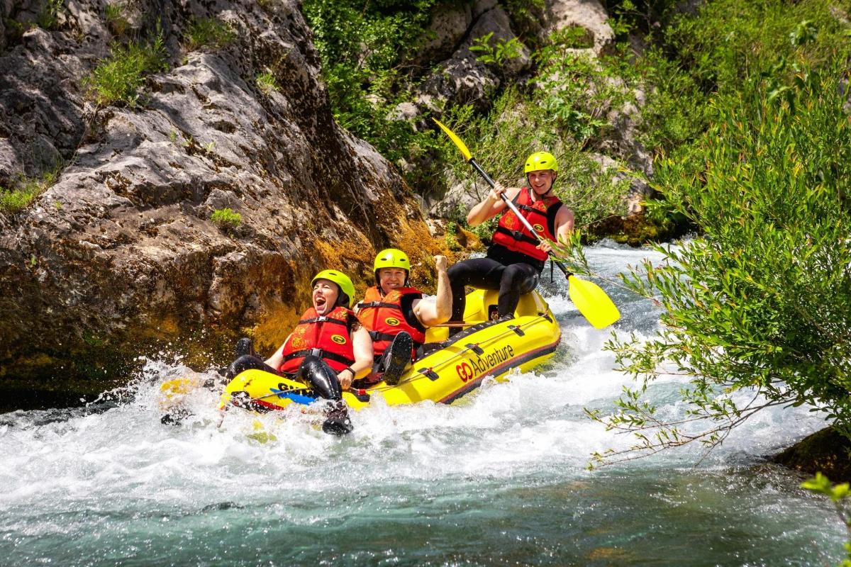 a group of people on a raft in a river