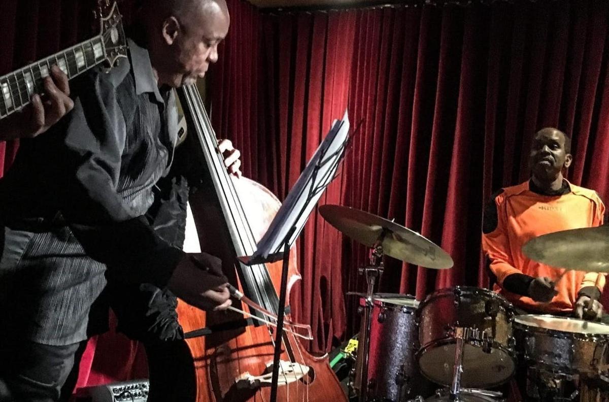 a man playing a instrument and a man playing drums