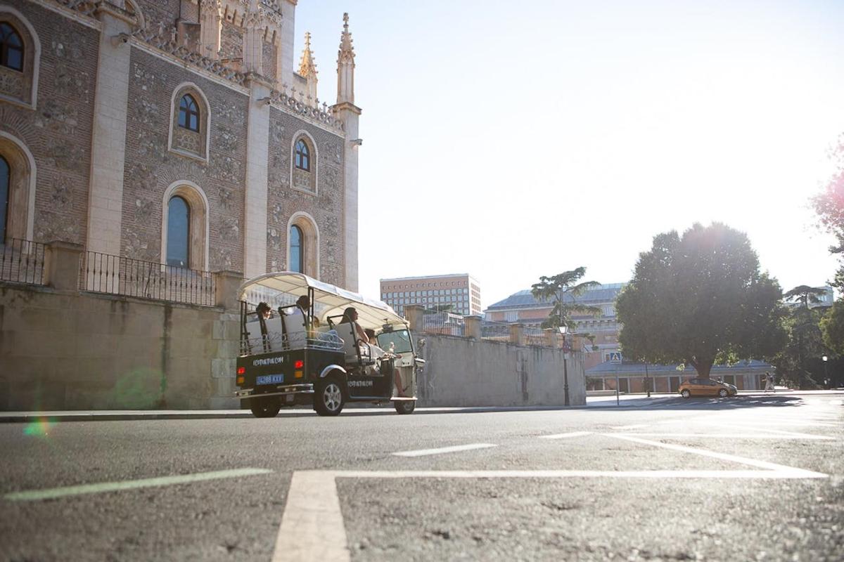 a truck driving down a street in front of a building