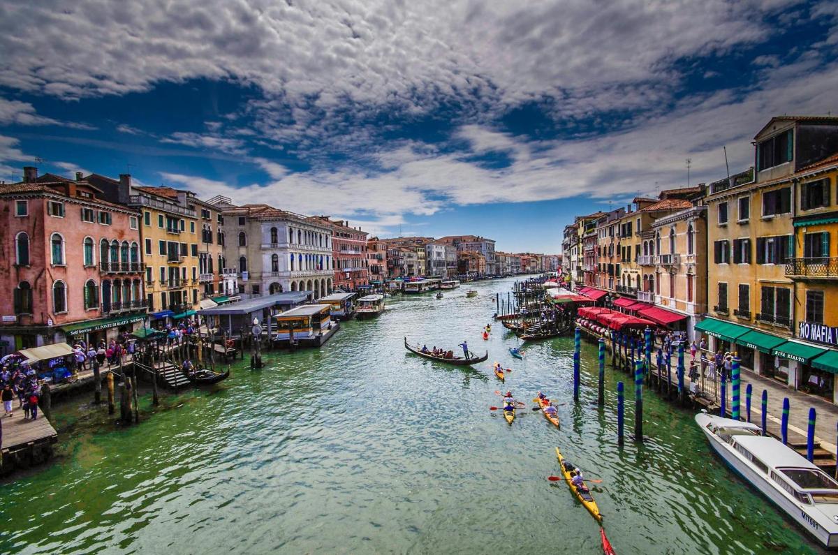 a view of a canal with boats and buildings