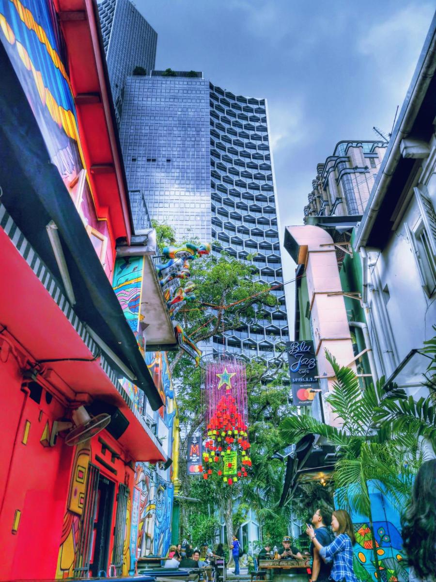 a city with tall buildings and people walking down a street