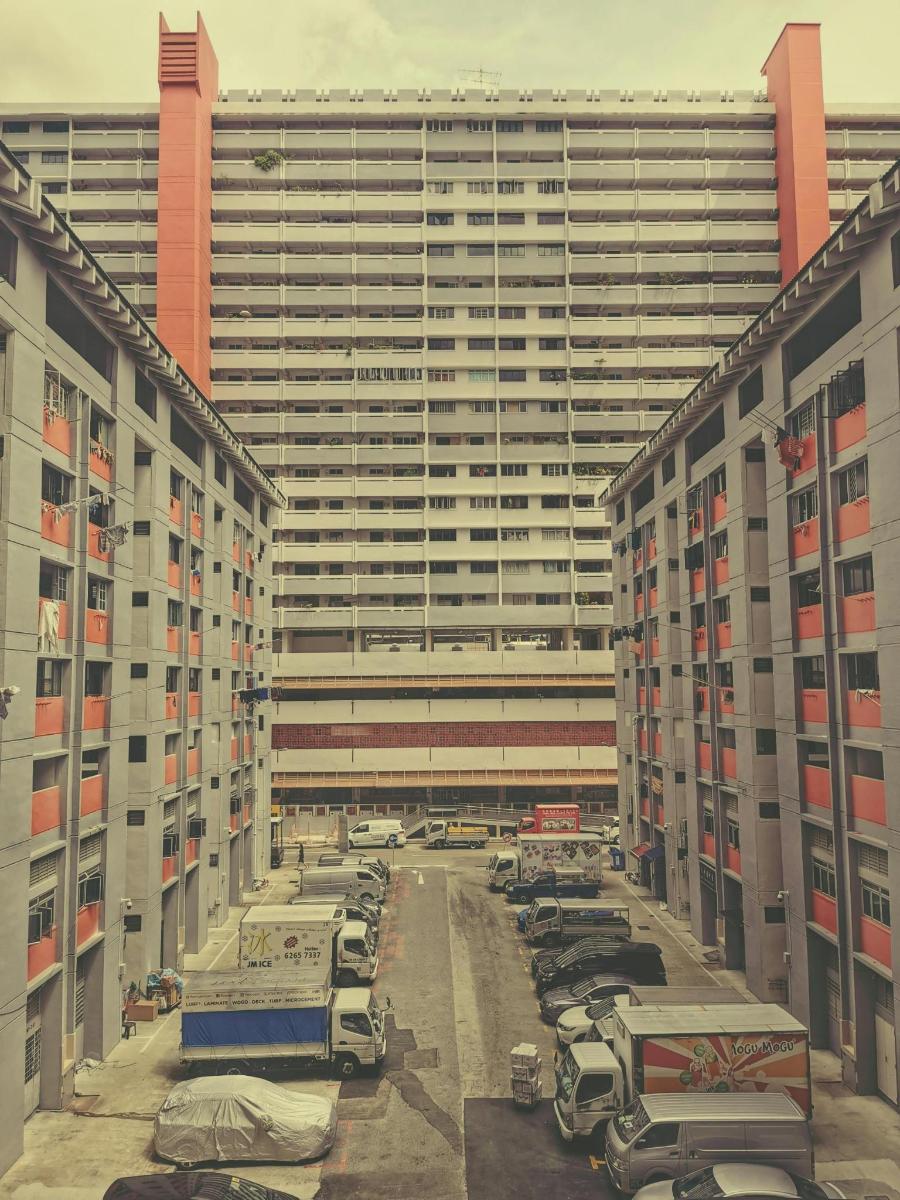 a parking lot with cars parked in front of a large building