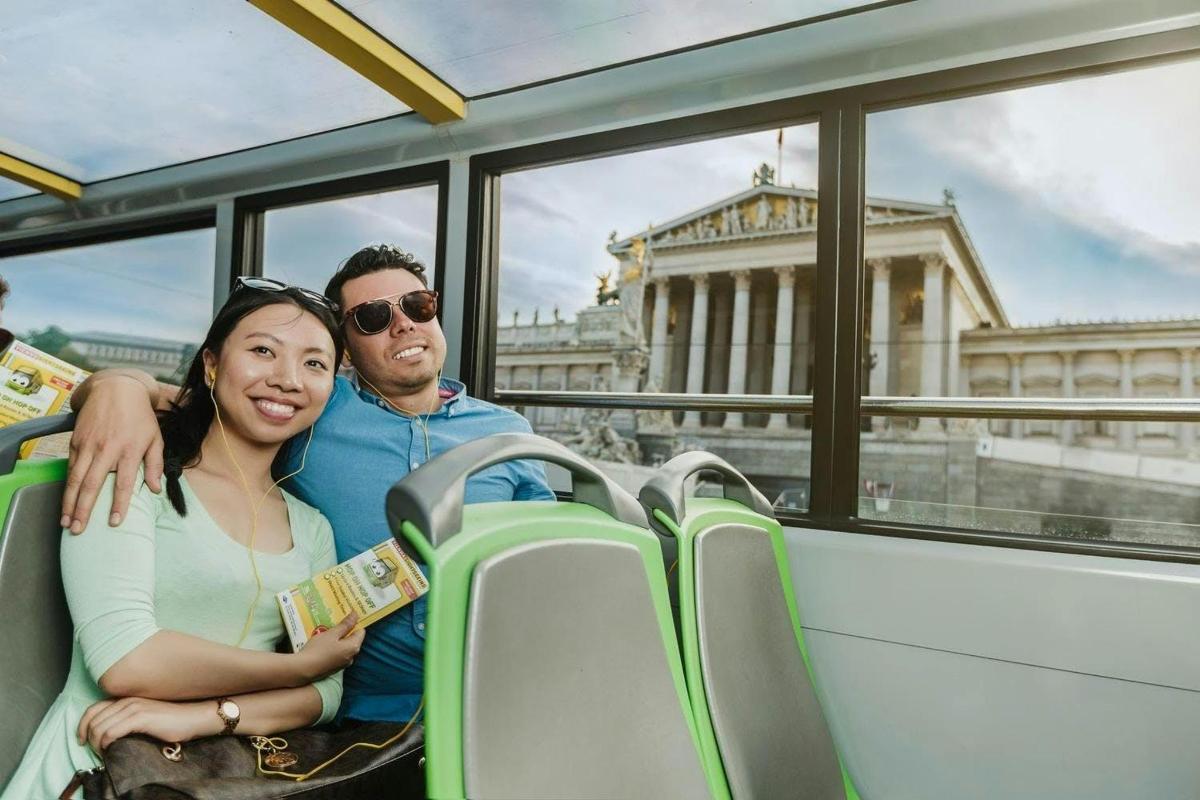 a man and a woman sitting on a bus