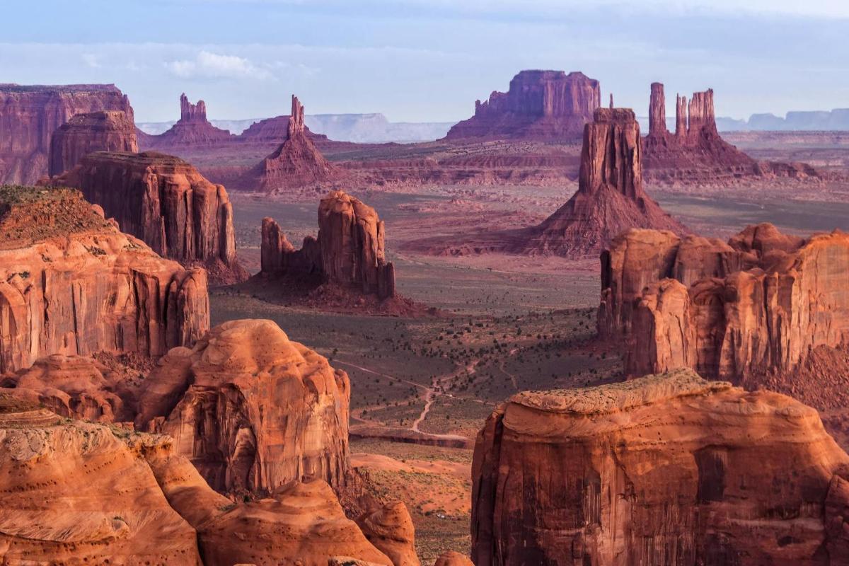a view of the desert with cliffs and formations