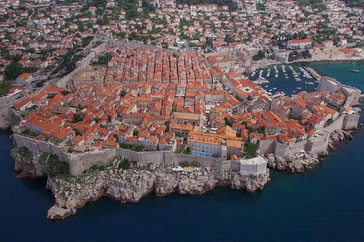 an aerial view of a city on a island in the water