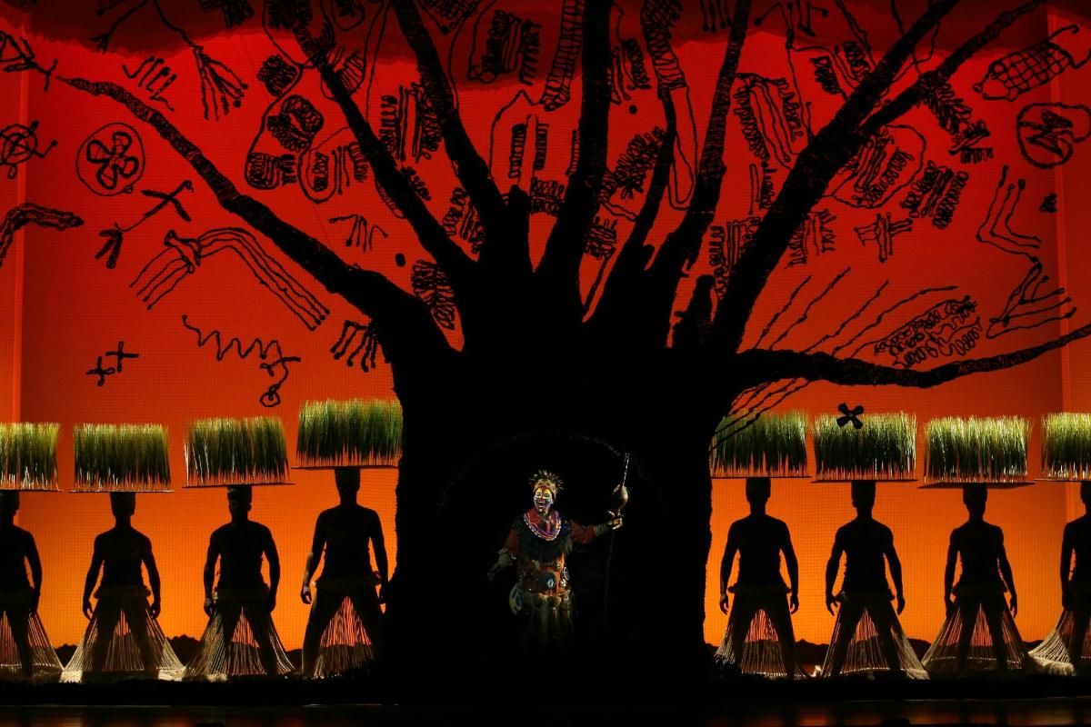 a group of people standing around a tree