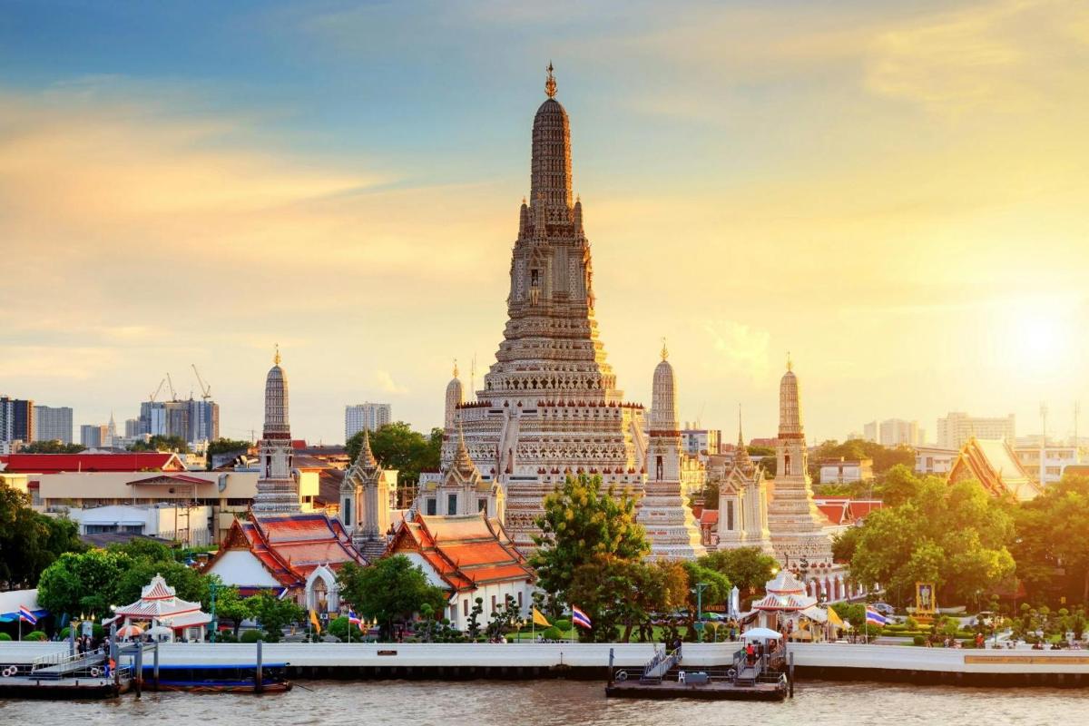 a view of a temple in a city with a river