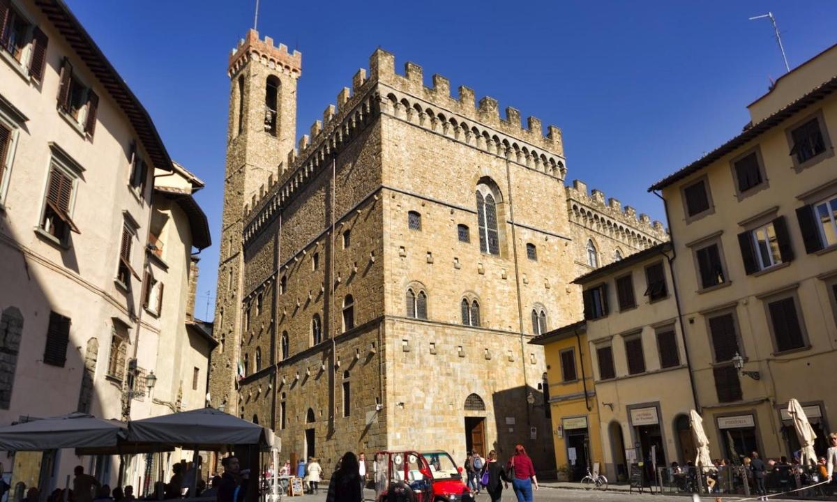 a large building with a clock tower in a city